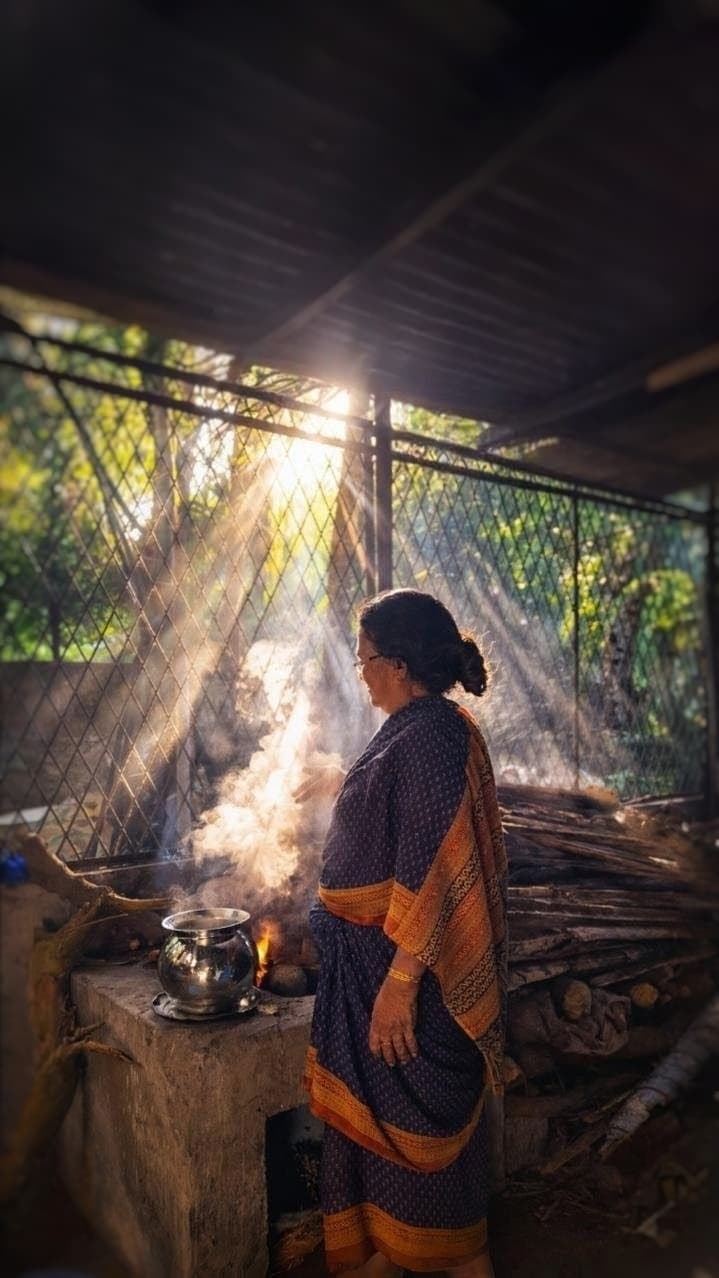 Traditional Kerala kitchen with brass vessels and wood-fired cooking